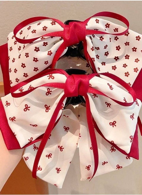 Add a touch of femininity and sophistication to your look with this hair bow. Designed with a double bow, this combination of white fabric is embellished with a heart and red dot pattern, finished with red satin trim for a stunning finish. The bow comes with a sturdy clip that secures the hair in place, perfect for anniversaries or special occasions.