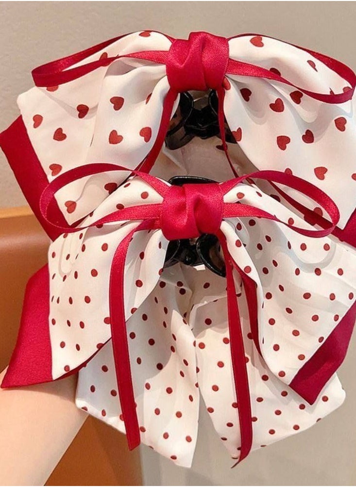 Generic - Add a touch of femininity and sophistication to your look with this hair bow. Designed with a double bow, this combination of white fabric is embellished with a heart and red dot pattern, finished with red satin trim for a stunning finish. The bow comes with a sturdy clip that secures the hair in place, perfect for anniversaries or special occasions. - Image 1