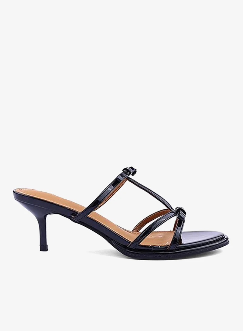 أيقون صنادل نسائية بكعب وحزام متقاطع