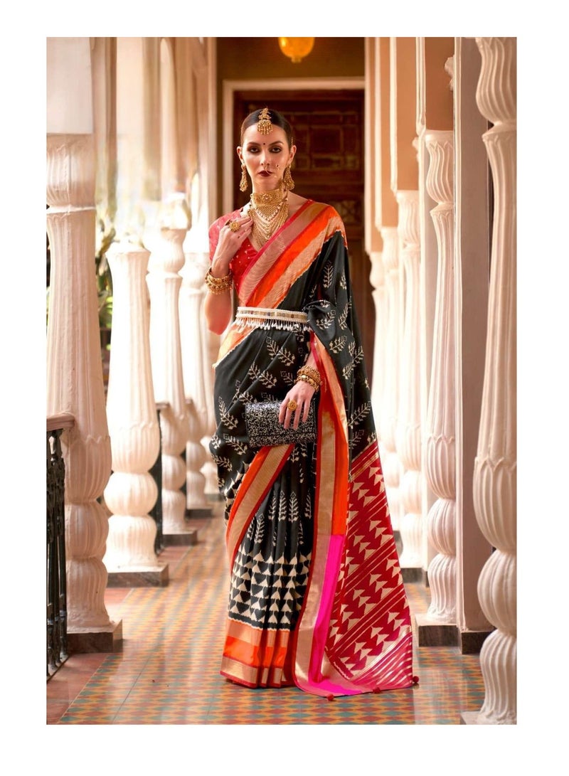 Grab Mantra Black Patola Print Saree With Red And Orange Border Design Plus Contrast Unstitched Blouse.  - Image 2