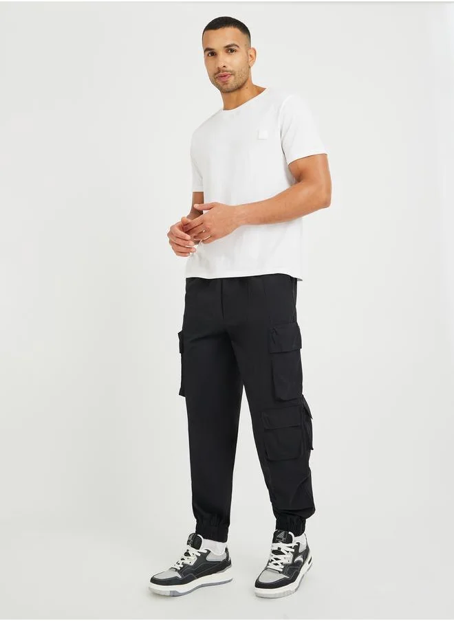ستايلي Styli Men Black Solid Cotton Twill Utility Relaxed Joggers with Multi Pockets