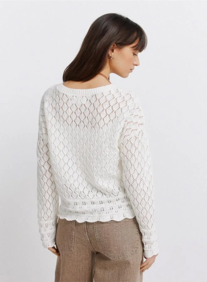 Springfield  Voluminous long sleeve jumper. Round neck. Pointelle knit with openwork details. Ribbed neck. Wavy hem and cuffs. This garment is made with sustainable cotton. for Women | Best Price UAE