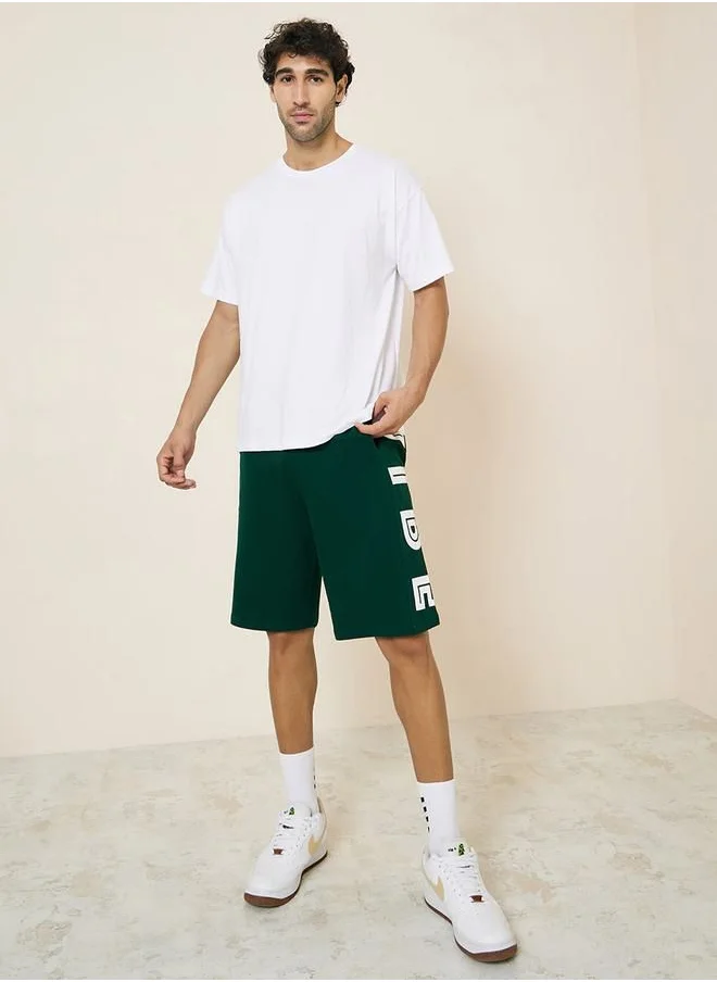 Styli Oversized Terry Shorts with Bold Text Print Detail