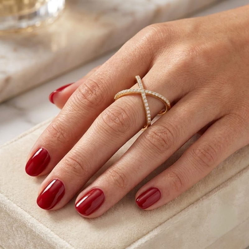 An elegant gold ring with a cross design, adorned with delicate rows of sparkling zircon stones. The open, adjustable design offers a modern and luxurious look that perfectly suits you. - Image 1
