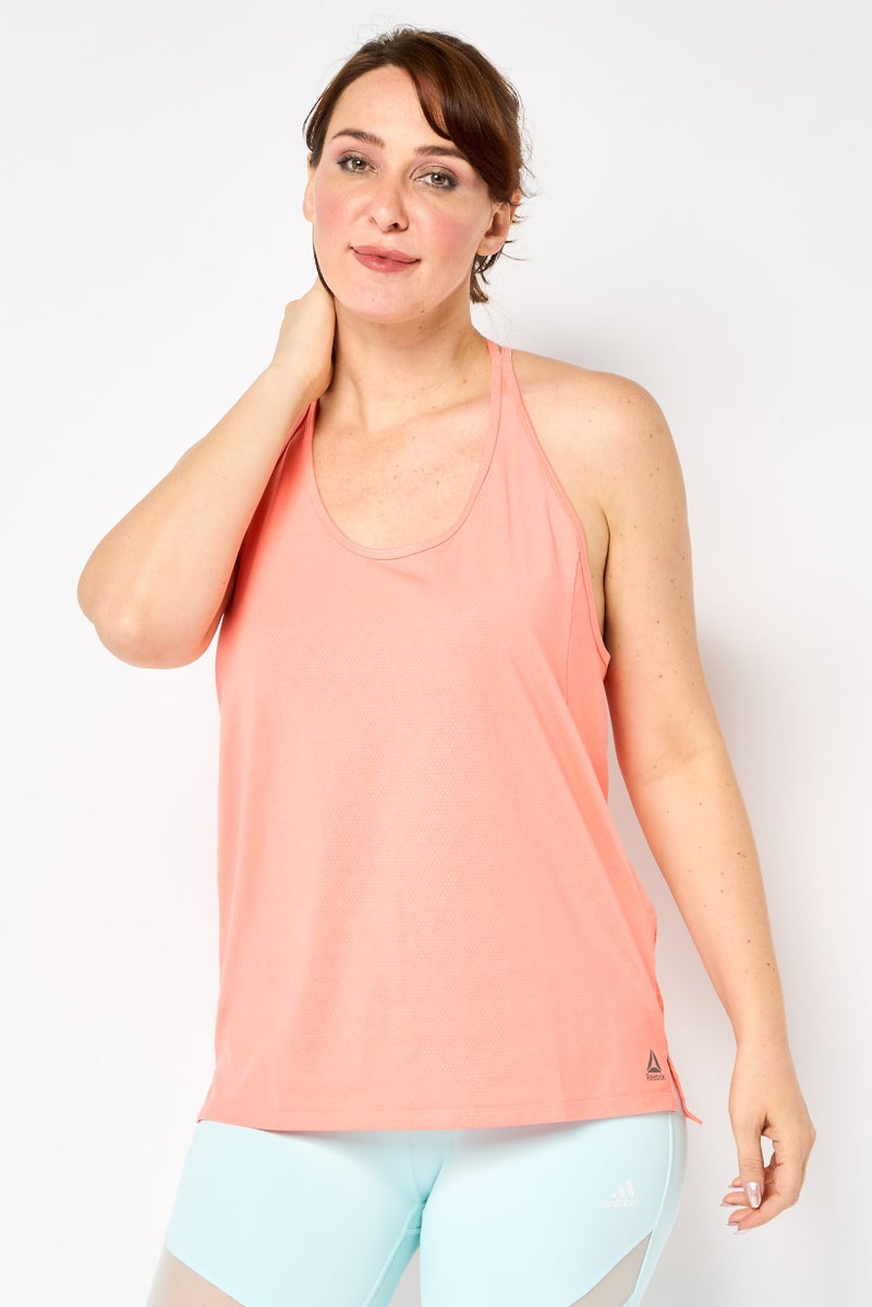 Reebok تي شيرت رياضي نسائي بدون أكمام بشعار العلامة التجارية، كورال - Image 1