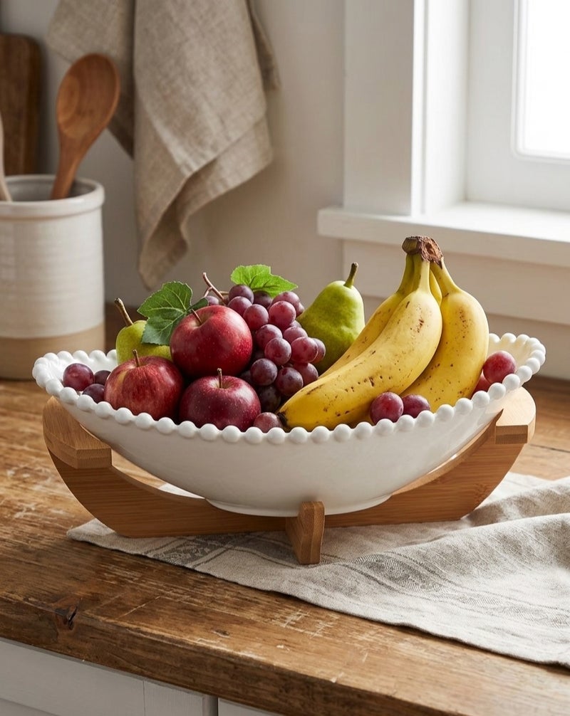 An elegant oval porcelain fruit bowl with a wooden base that adds a modern and stylish touch to your serving table. - Image 3