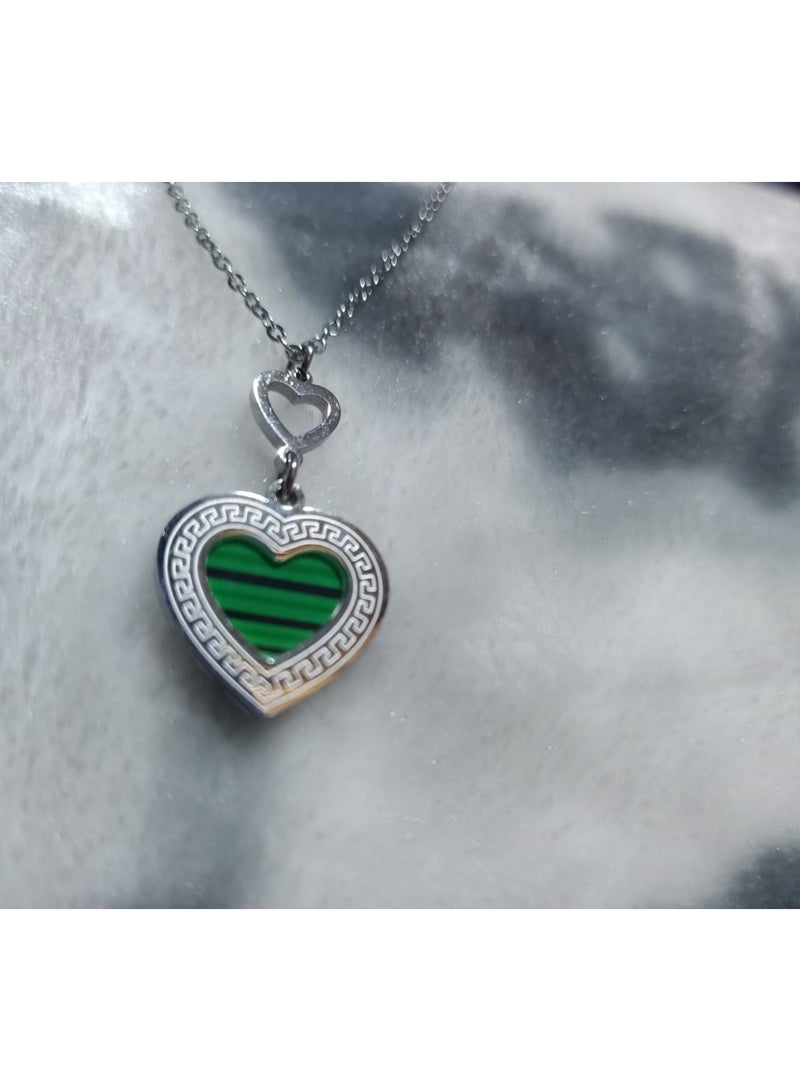 Luxuria A necklace featuring a heart-shaped pendant with a green malachite-like stone and a Greek key pattern. - Image 1