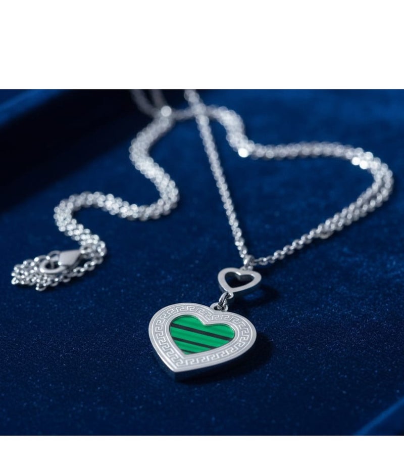 Luxuria A necklace featuring a heart-shaped pendant with a green malachite-like stone and a Greek key pattern. - Image 1