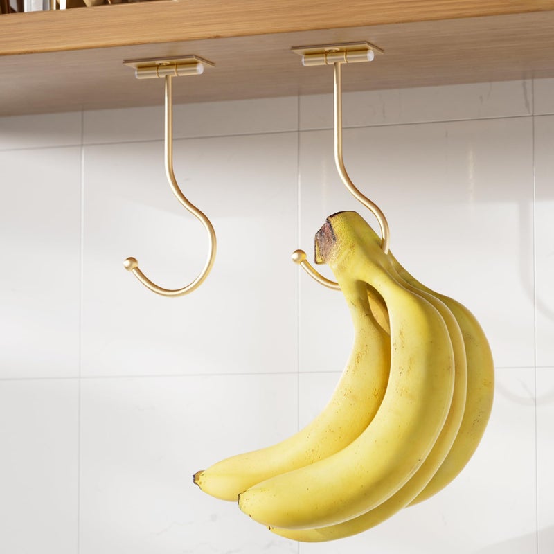 Josmimic Modern Banana Hanger Hook Under Cabinet Adhesive Banana Holder Foldable with Magnets When Not in Use Under Counter Banana Hook Stainless Hold 13 LB Gold 2 Pack