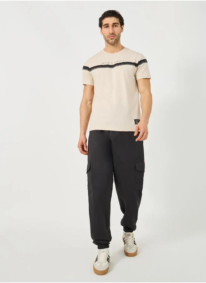 Styli Styli Contrast Panel Slogan Print Regular Fit T-Shirt with Badge Detail