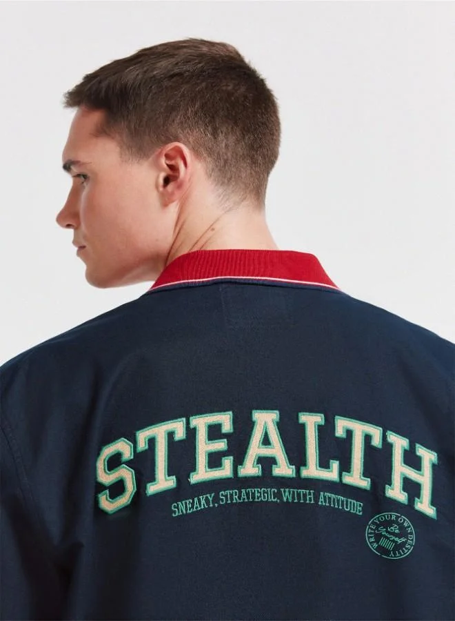 Springfield  1% cotton oxford boxy fit short sleeve shirt with a ribbed polo collar with stripes, letter patches with embroidery on the back and chest, and a tonal button. for Men | Best Price UAE