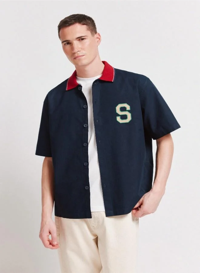Springfield  1% cotton oxford boxy fit short sleeve shirt with a ribbed polo collar with stripes, letter patches with embroidery on the back and chest, and a tonal button. for Men | Best Price UAE