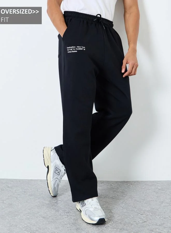 Styli Men Black Slogan Print Oversized Joggers