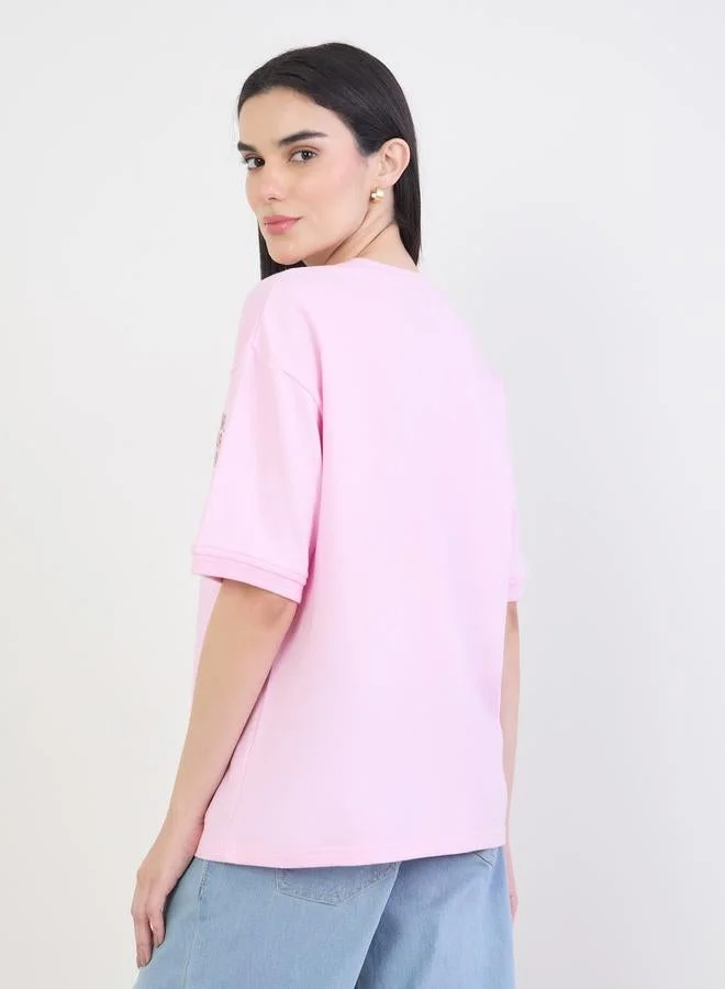 Styli  Pink Oversized Slogan Print T-Shirt for Women | Best Price UAE