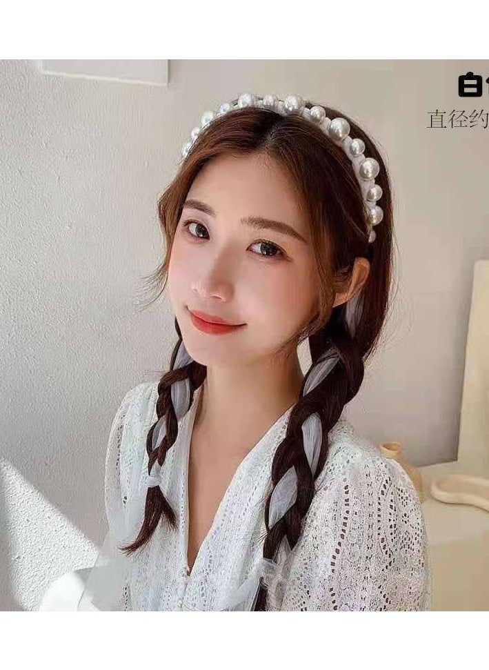 A hair tie with a ribbon for Luli