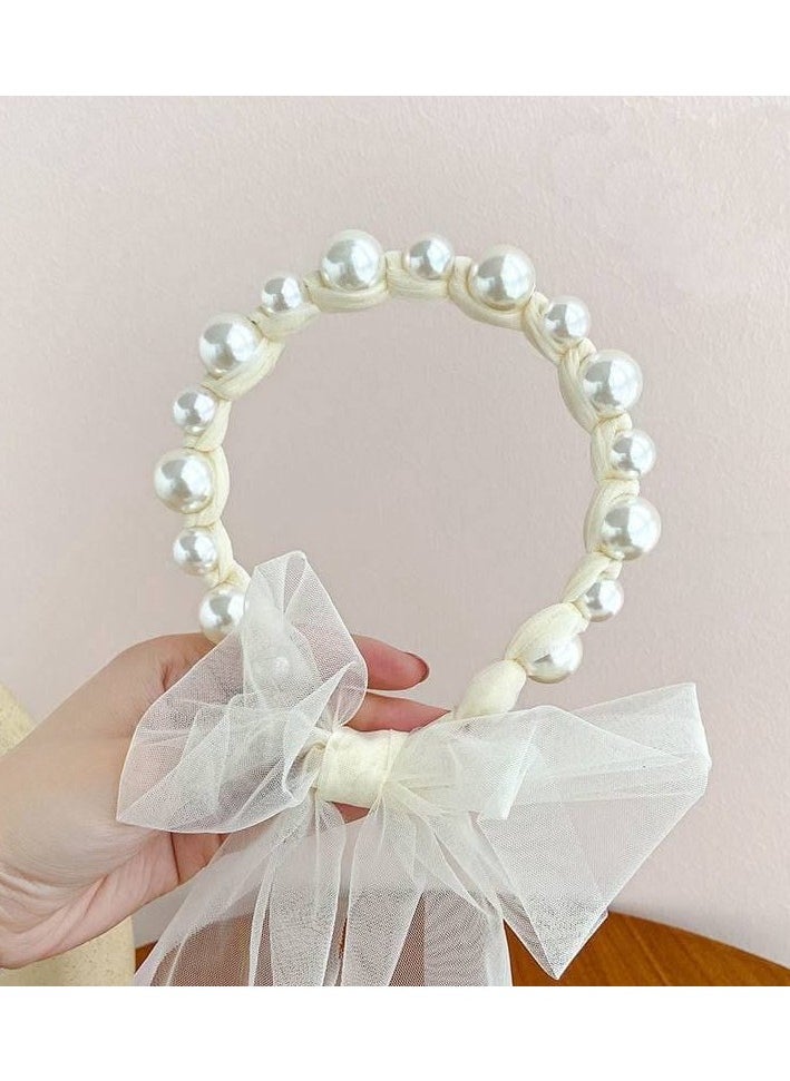 A hair tie with a ribbon for Luli