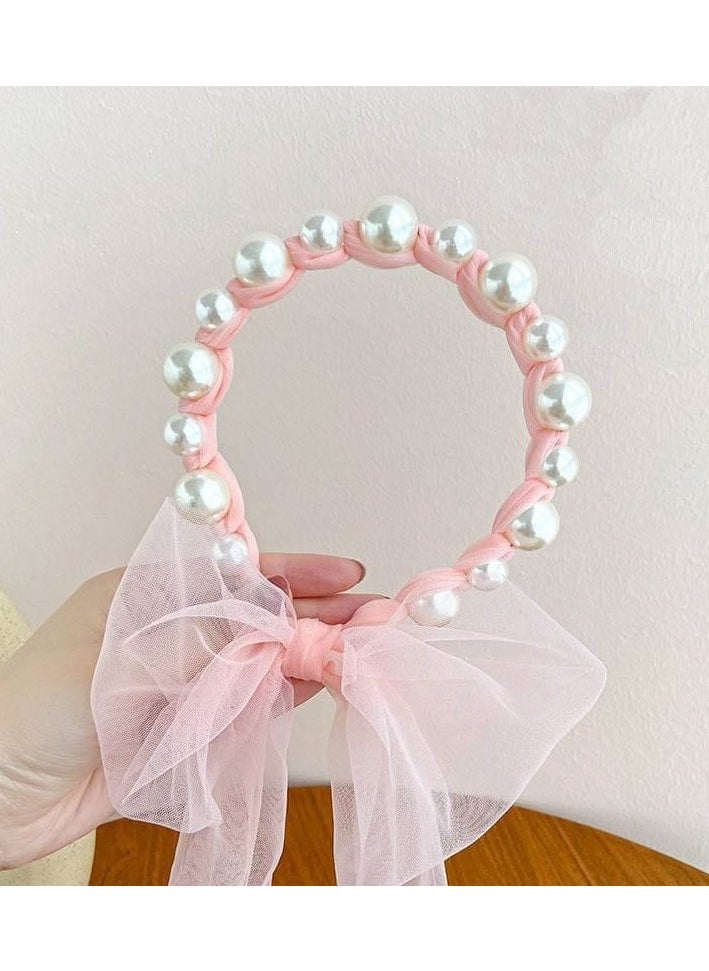 A hair tie with a ribbon for Luli