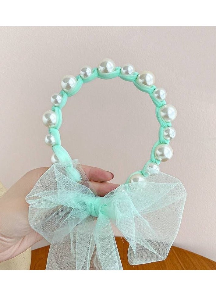 A hair tie with a ribbon for Luli
