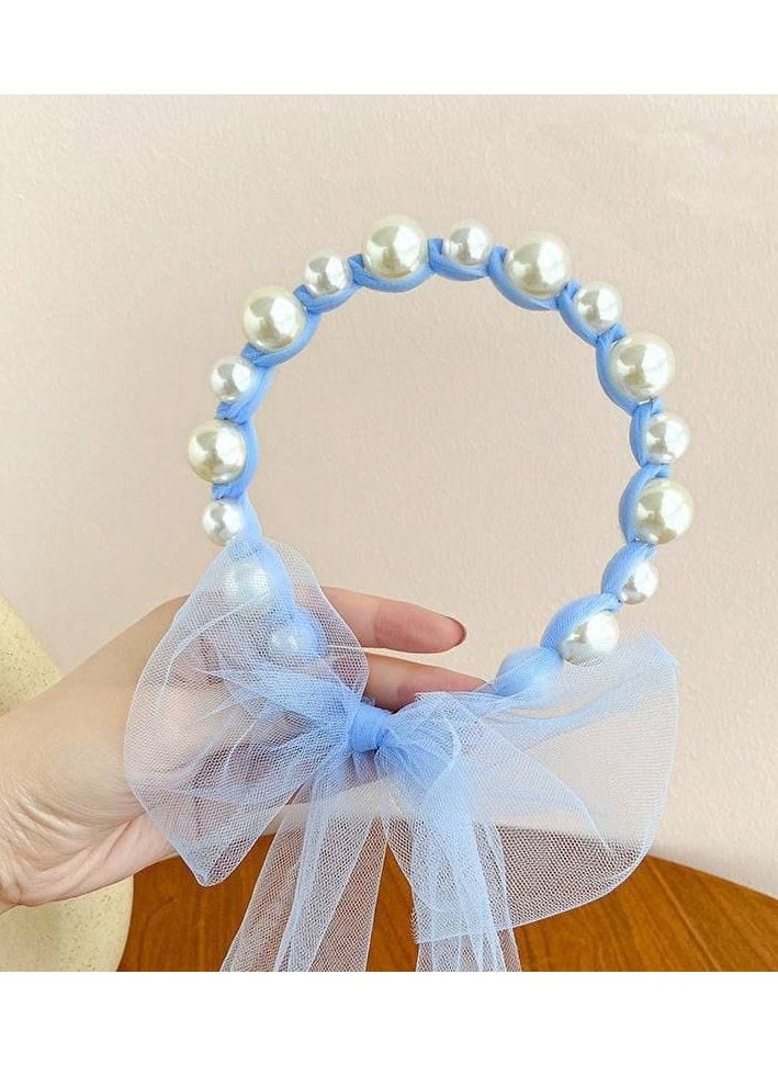 A hair tie with a ribbon for Luli