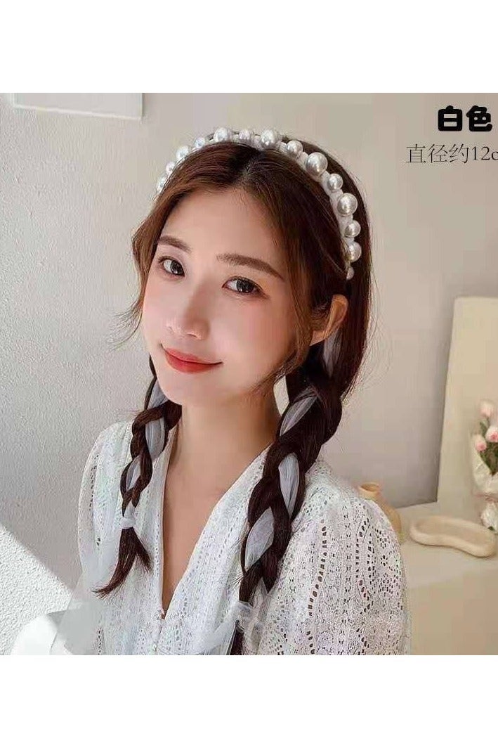 A hair tie with a ribbon for Luli