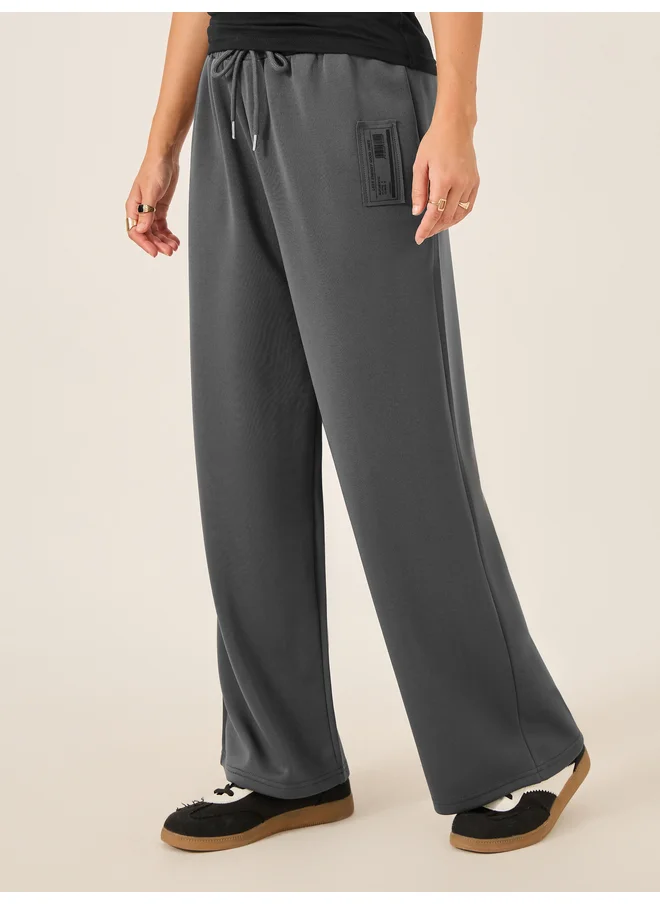 ستايلي Styli Badge Detail Scuba Wide Leg Joggers