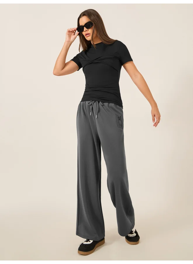 ستايلي Styli Badge Detail Scuba Wide Leg Joggers