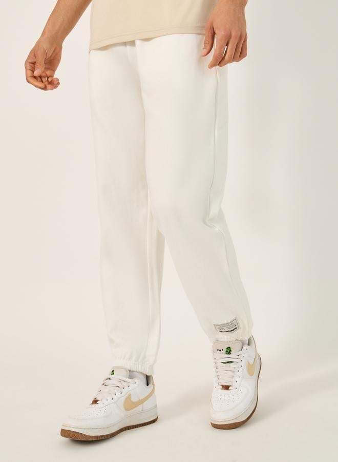 Styli Fleece Mid Rise Relaxed Fit Joggers with Badge Detail  - Image 1