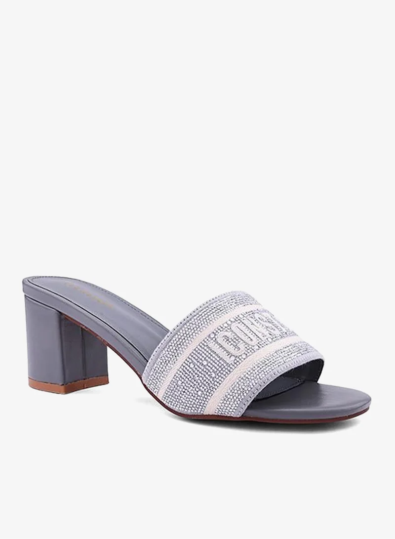 أيقون صنادل بكعب مزينة بأشرطة