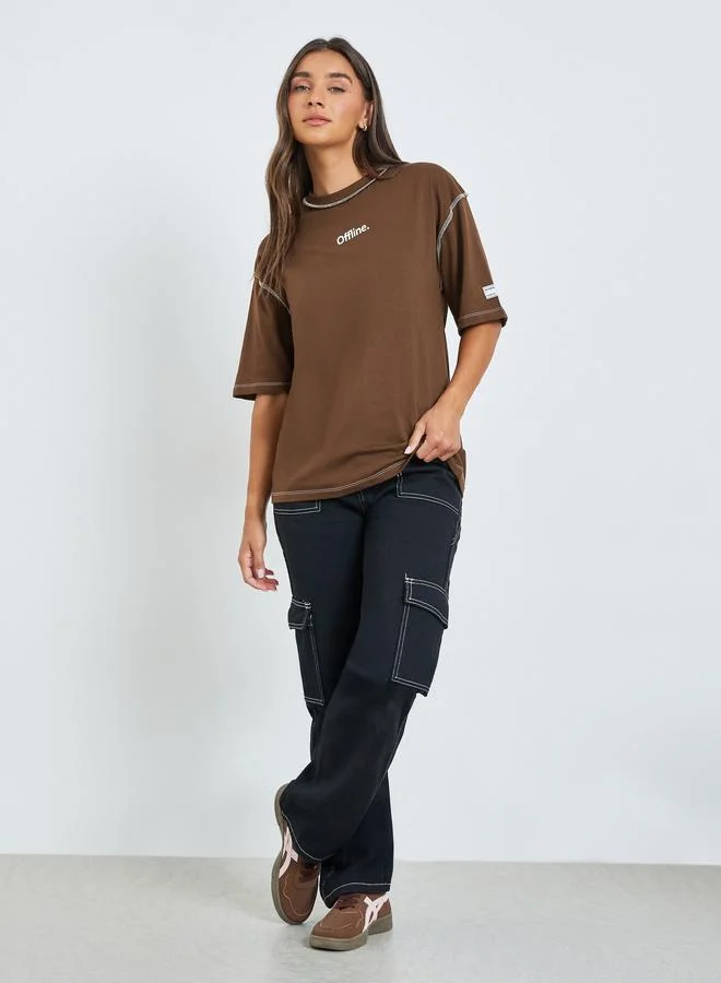 Styli Oversized Drop Shoulder Slogan T-Shirt With Exposed Seam