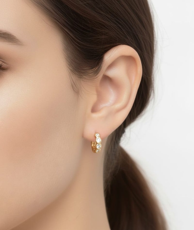 A delicate gold-plated hoop featuring a wavy wrap design, studded with sparkling stones. - Image 2