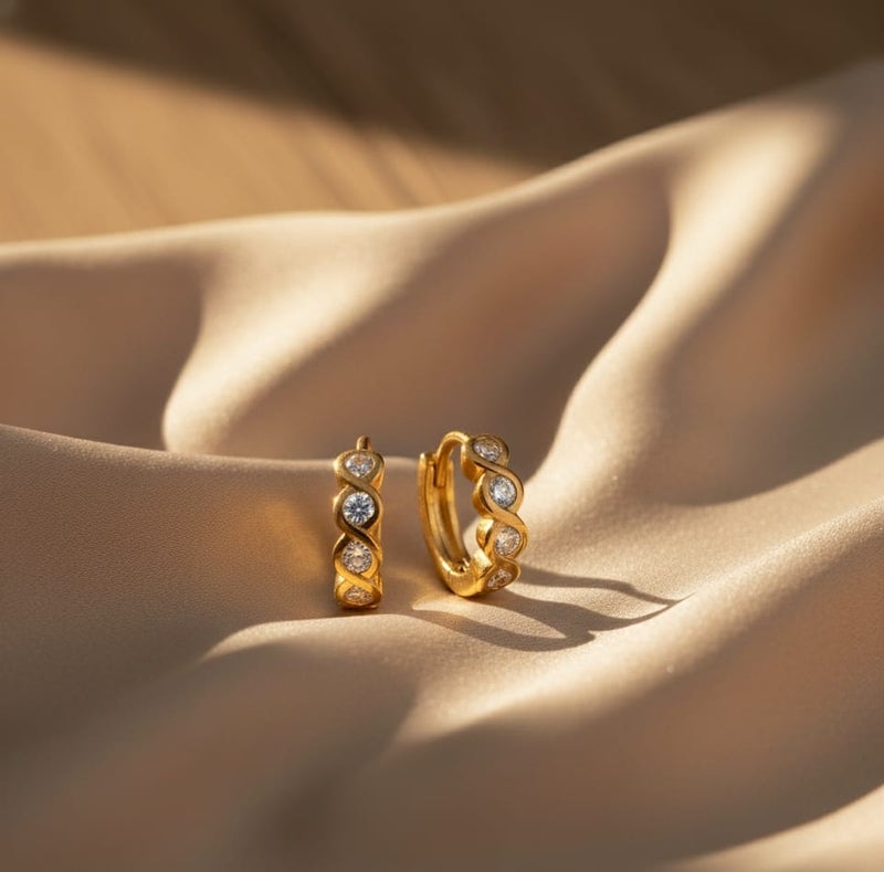 A delicate gold-plated hoop featuring a wavy wrap design, studded with sparkling stones. - Image 5