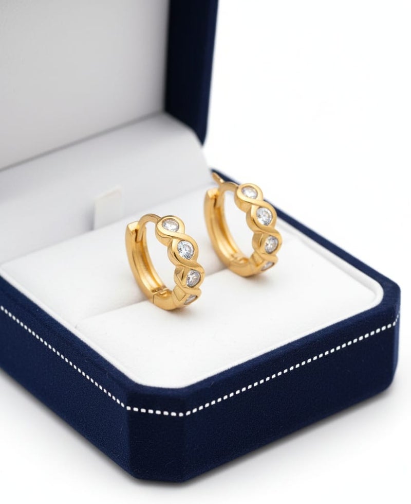 A delicate gold-plated hoop featuring a wavy wrap design, studded with sparkling stones. - Image 3