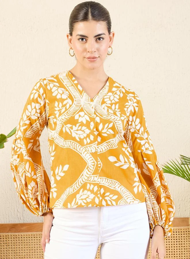 أبتاوني قميص برتقالي بطباعة زهور وأكمام منفوخة