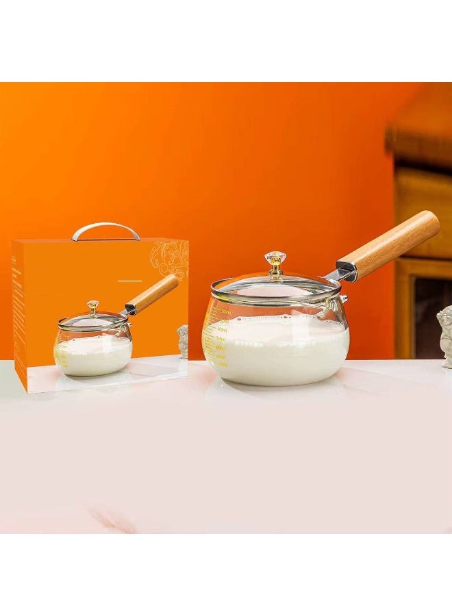 An elegant glass milk casserole with a heat-resistant wooden lid and handle, ideal for boiling milk and preparing drinks and sauces.