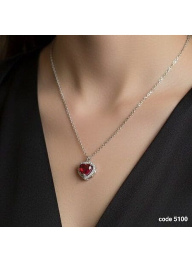Luxuria A heart-shaped pendant set with a red ruby ​​and surrounded by a halo of clear stones. The pendant boasts a classic and romantic design, crafted from silver-plated stainless steel, and features cubic zirconia and synthetic rubies. - Image 2
