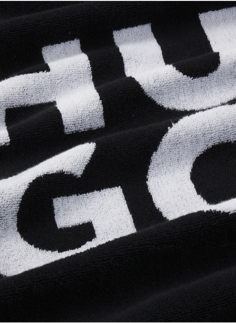 HUGO Beach towel in cotton-terry jacquard with stacked logo