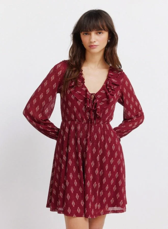 Springfield  Printed semi-fitted V-neck double ruffle tie fastening underbust cut flared skirt ruffled cuffs short dress for Women | Best Price UAE