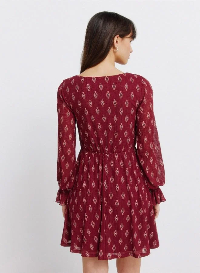 Springfield  Printed semi-fitted V-neck double ruffle tie fastening underbust cut flared skirt ruffled cuffs short dress for Women | Best Price UAE