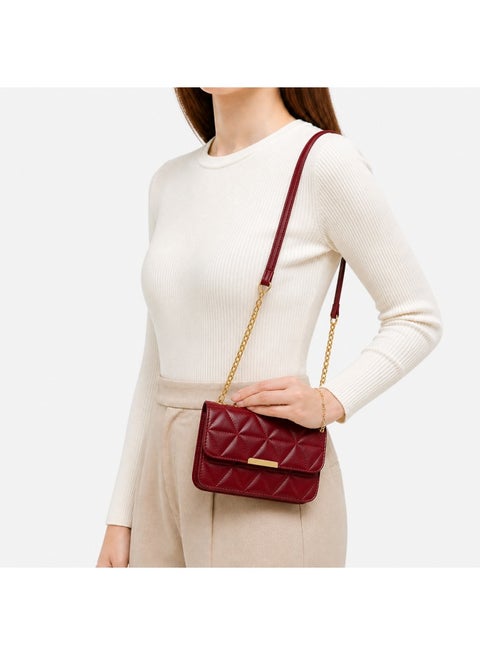 Women's padded shoulder bag with a stylish crossbody design – luxurious leather with a gold chain and metal clasp
