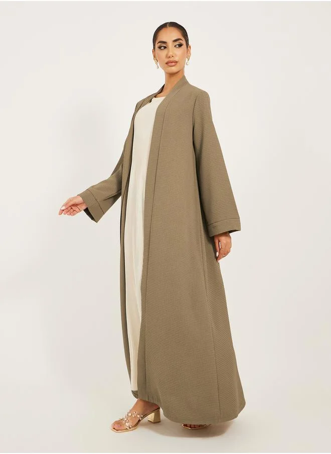 Styli texture fabric front open abaya with high neck detail