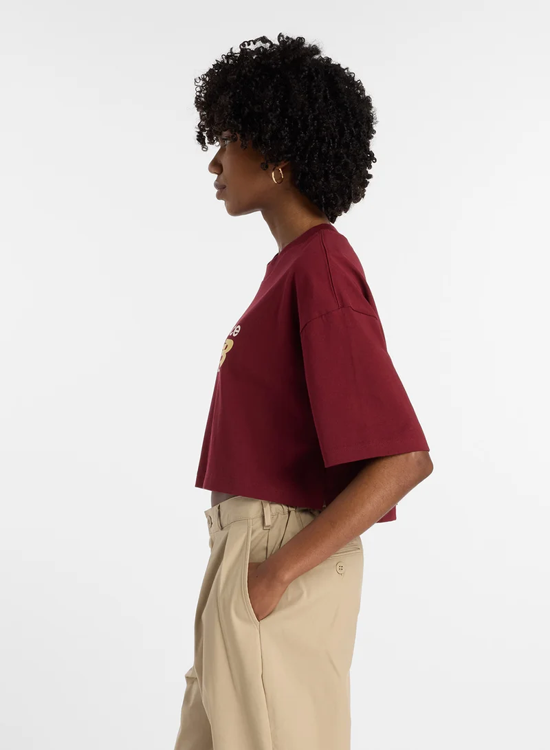 New Balance Athletics Premium Chest Logo Cropped T-Shirt