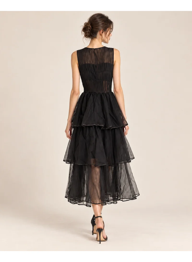 2Trendy Women's Black Midi Sleeveless Dress with Sheer Tiers and Ruched Bodice