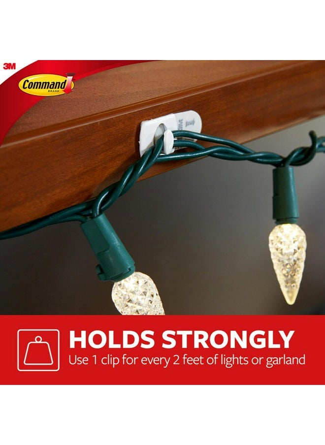 Command - Command Decorating Clips, 40 Clips and 48 Command Strips, Damage Free Hanging Light Clips with Adhesive Strips, No Tools Small Wall Clips for Hanging Lights and Cables for Christmas Decorations - Image 1