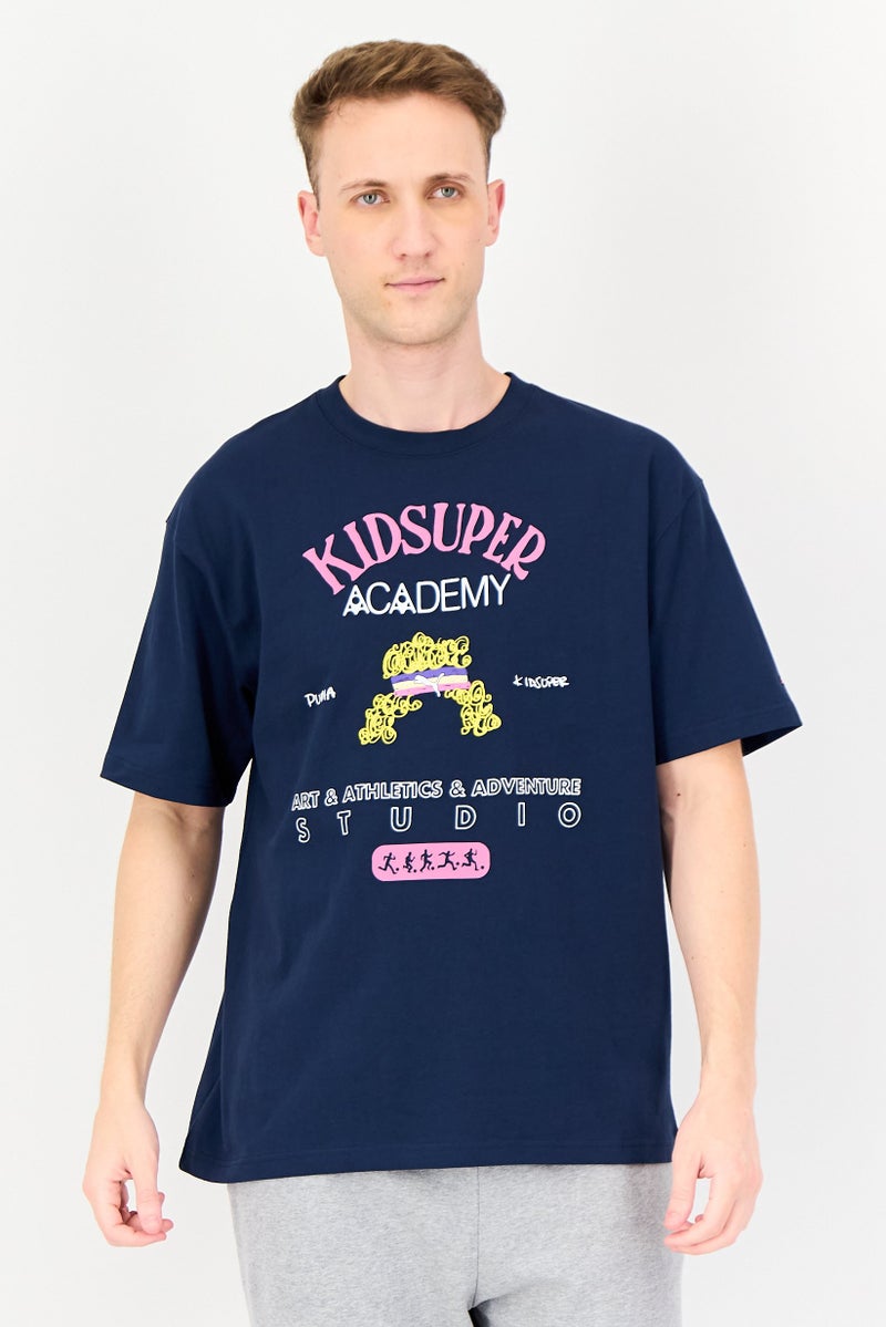 Puma X Kidsuper Men Sportswear Fit Short Sleeve Outdoor T-Shirt, Navy - Image 1