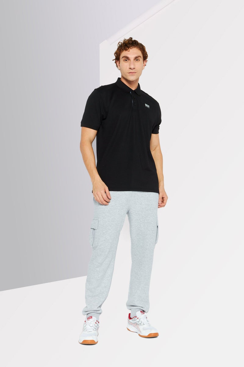 DKNY Sport قميص بولو رياضي للرجال بأكمام قصيرة مناسب للخارج، أسود - Image 2