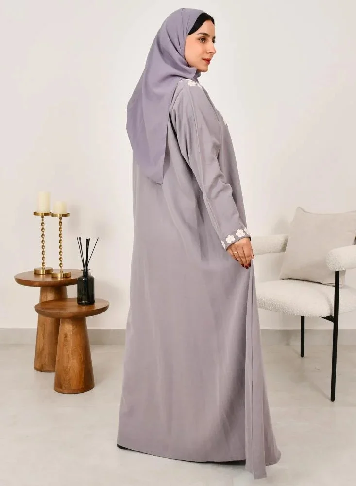 lamha abaya Elegant quarter-cloche abaya in light gray with prominent white embroidery on the sides of the abaya and sleeves