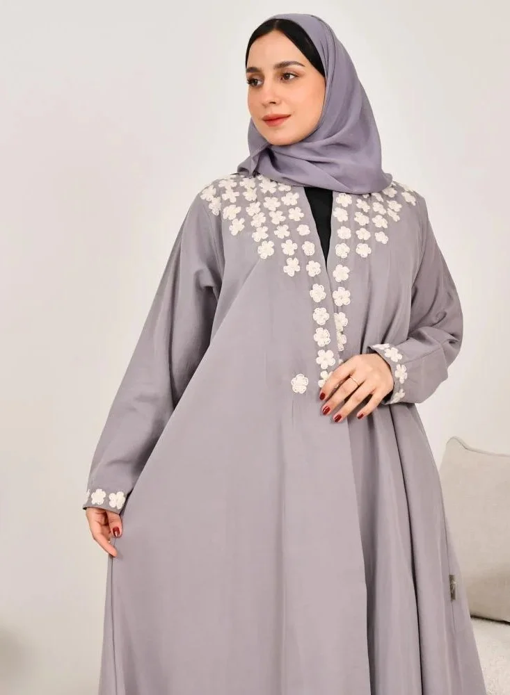 lamha abaya Elegant quarter-cloche abaya in light gray with prominent white embroidery on the sides of the abaya and sleeves