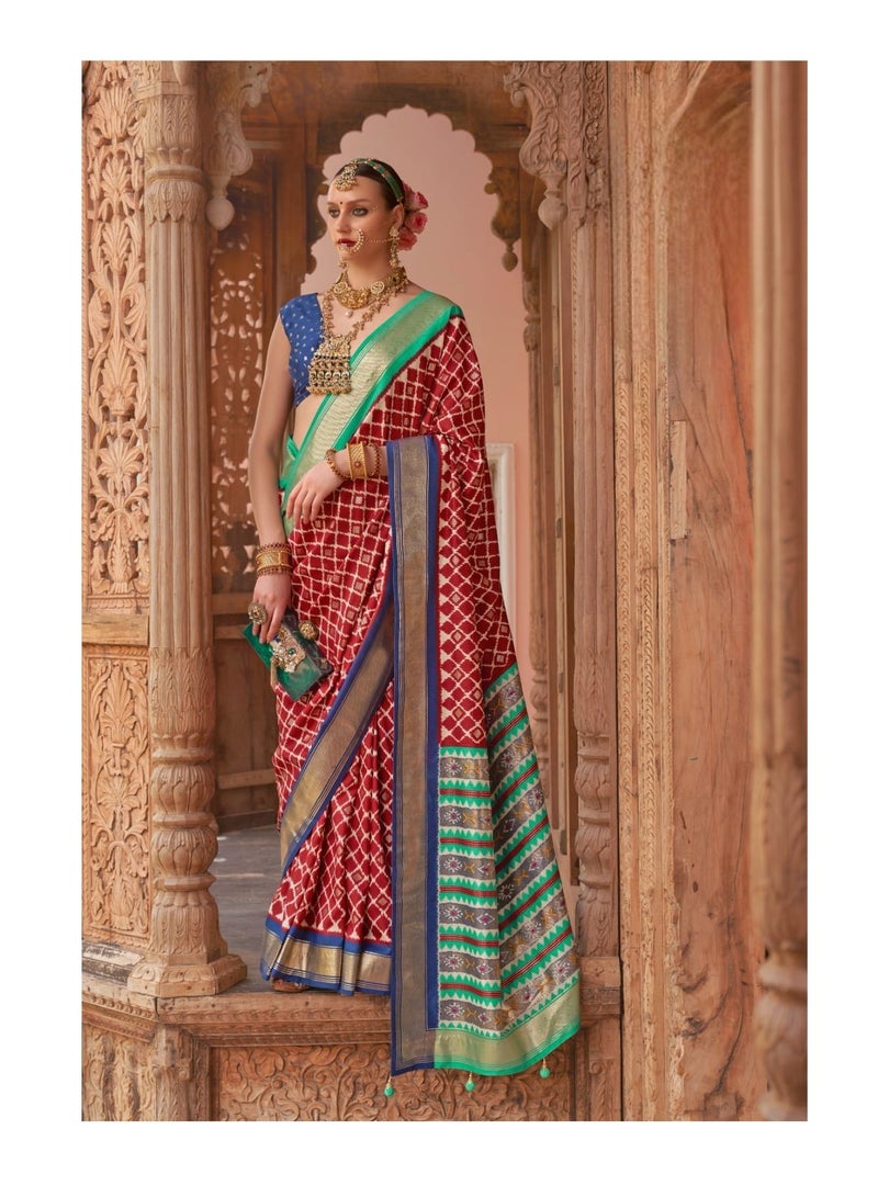 Grab Mantra Traditional Silk Red Saree With Green Border And Pallu Having Patola Design Plus Unstitched Blue Blouse  - Image 2