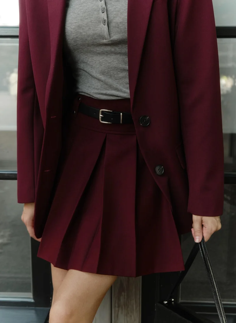 Lichi Mini pleated skirt with eco-leather belt