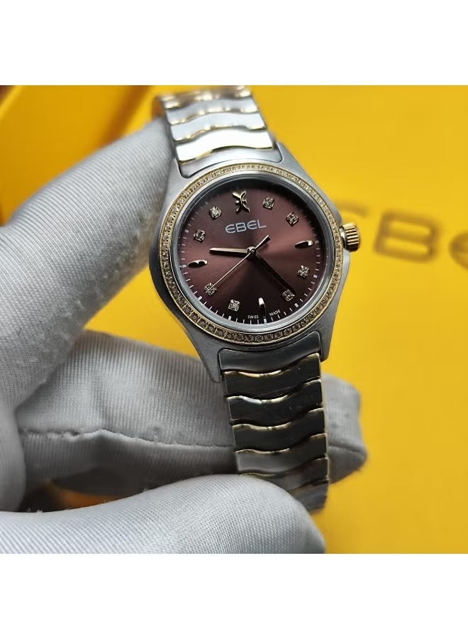 The Ebel women's watch features a classic design with a distinctive wave-shaped strap.
